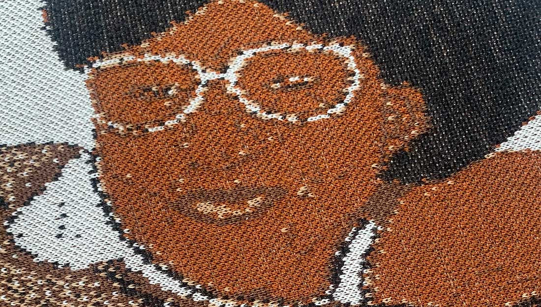 A close up of an embroidered face.