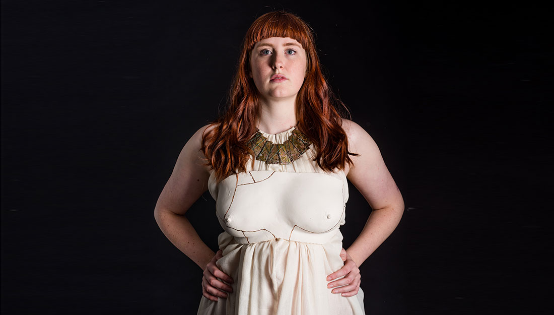 A pale dress with marked lines like body shapes.