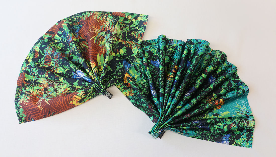 Fans made of cloth printed with a pattern of birds and trees.