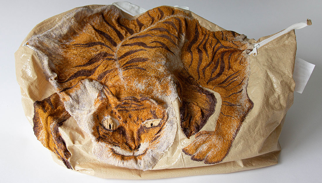 A bag embroidered with a large detailed tiger.