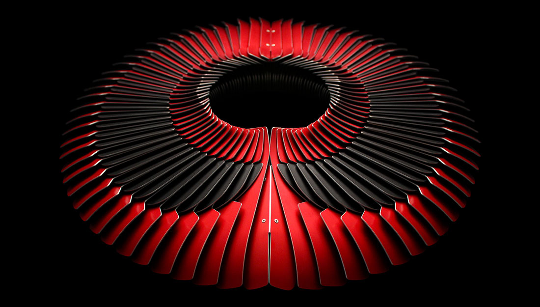 A beautiful and striking red and black neckpiece made of lots of small sections reminiscent of neatly layered feathers.