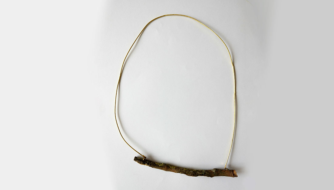 A simple necklace made from a stick and cord.
