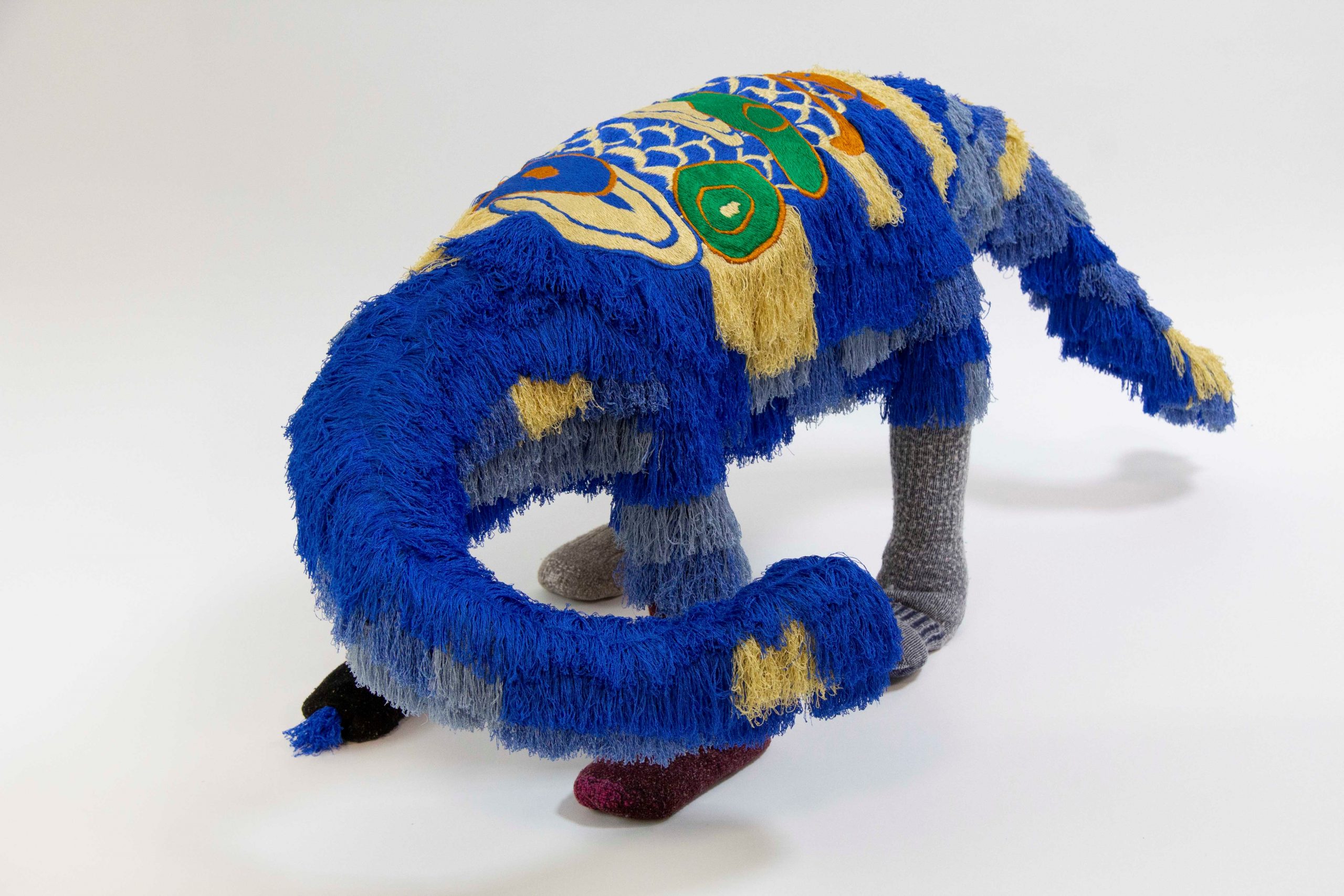 A strange dragonlike creature made from recycled textiles.