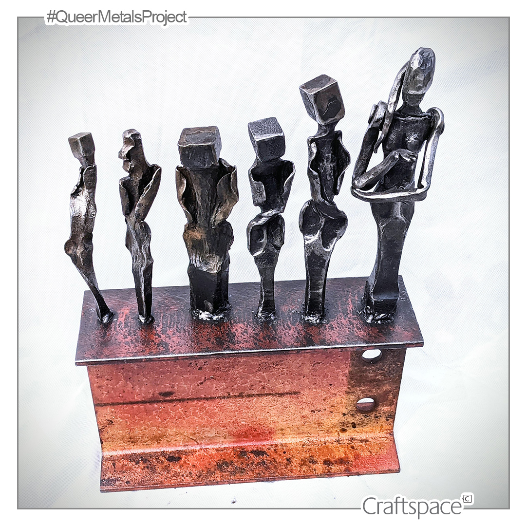 Six figures forged in steel are lined up, ranging in height from left to right, positioned on an an aged and patinated I Beam.