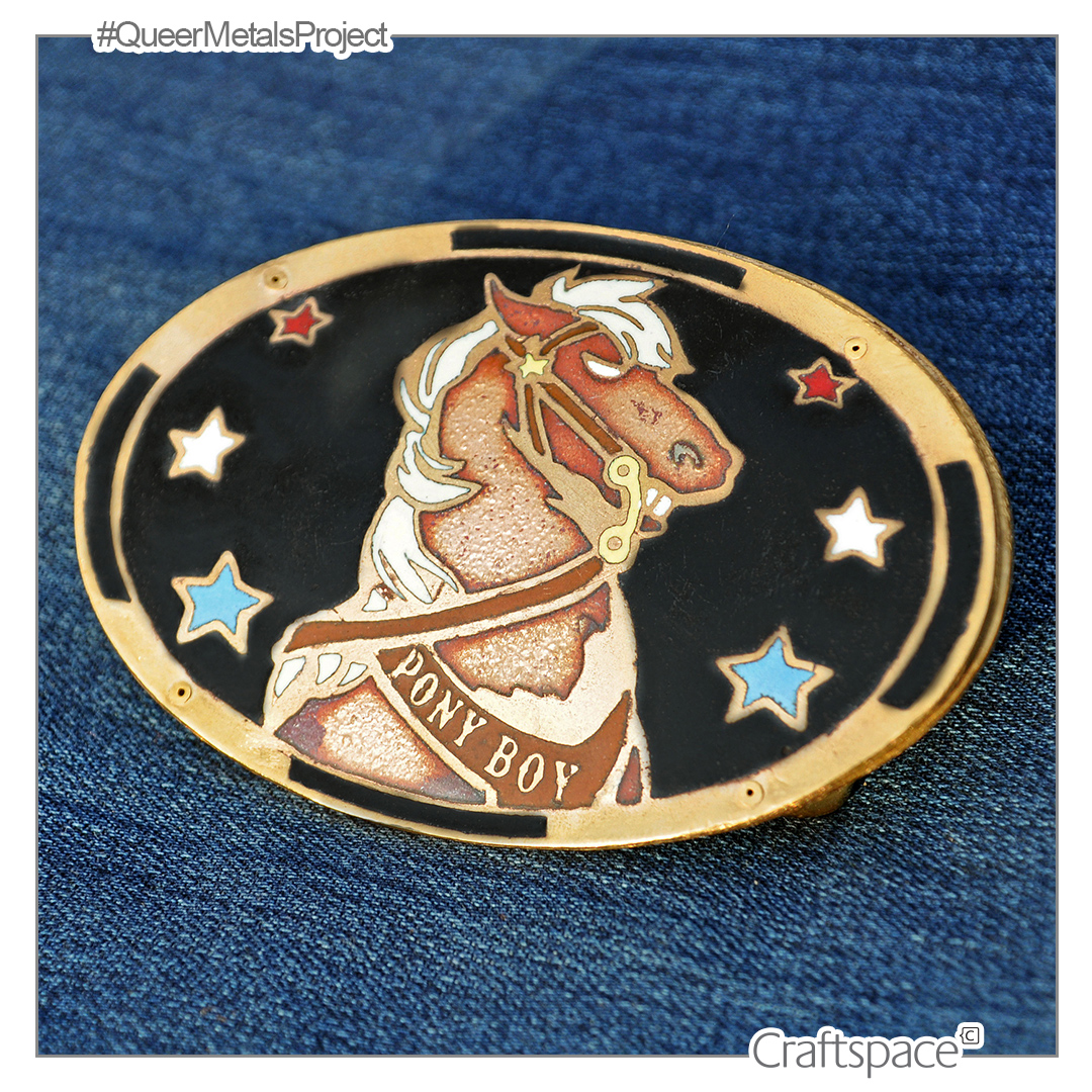 An enamel badge depicting a pony with the words Pont Boy visible on it's chest on a black background with blue white and red stars