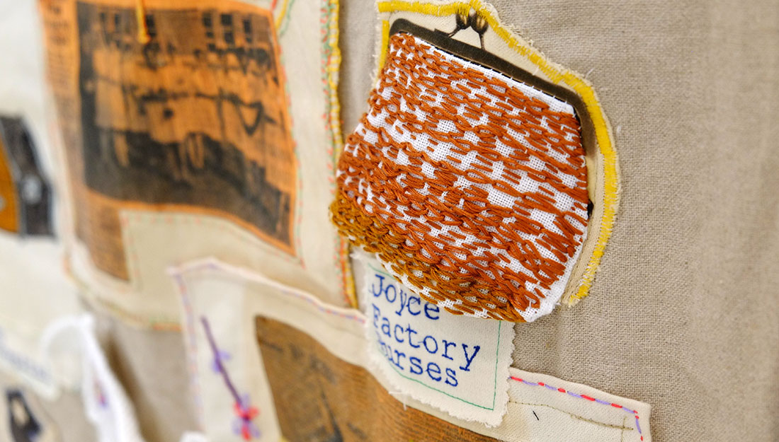 An embroidered purse, text says 'Joyce, Factory, Purses'.