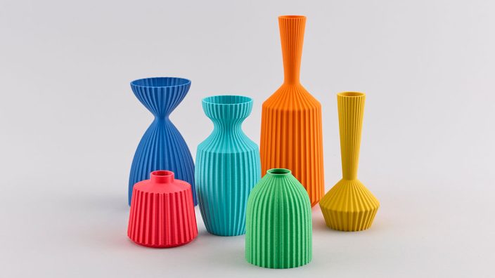 Six brightly coloured, differently sized vases. Each vase is entirely one colour, and differently shaped. The surfaces are decorated with many sharp grooves, creating lines top to bottom.