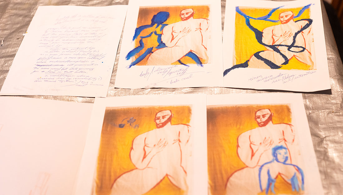 CraftingPathways_Abigail&Oly_PhotoHayleySalter_1100x625_6 A close-up of four copies of Abigail's work, each of which has been drawn on in different ways using blue oil pastels.